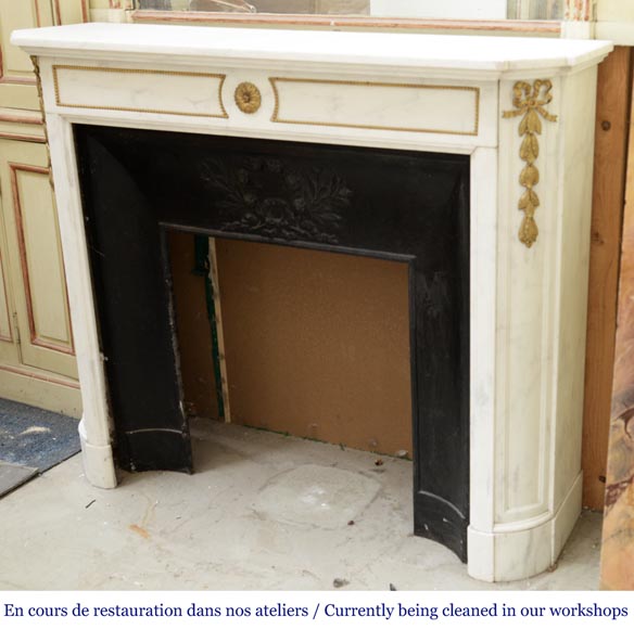 An antique Louis XVI style fireplace made out of Carrara marble with gilded bronze ornaments-5