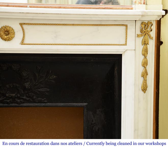 An antique Louis XVI style fireplace made out of Carrara marble with gilded bronze ornaments-6