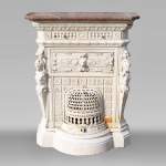 Antique cast iron stove in the Napoleon III style decorated with caryatids