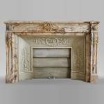 An antique Louis XVI style fireplace in Skyros marble