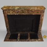 Antique Louis XVI style fireplace with round corners in Red from the North marble and gilded bronze ornaments