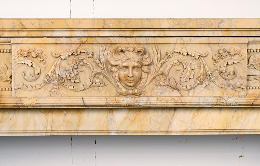 Large Louis XVI style mantel in yellow Sienna marble with entablature adorned with the head of Apollo and arrow heads on the jambs-1