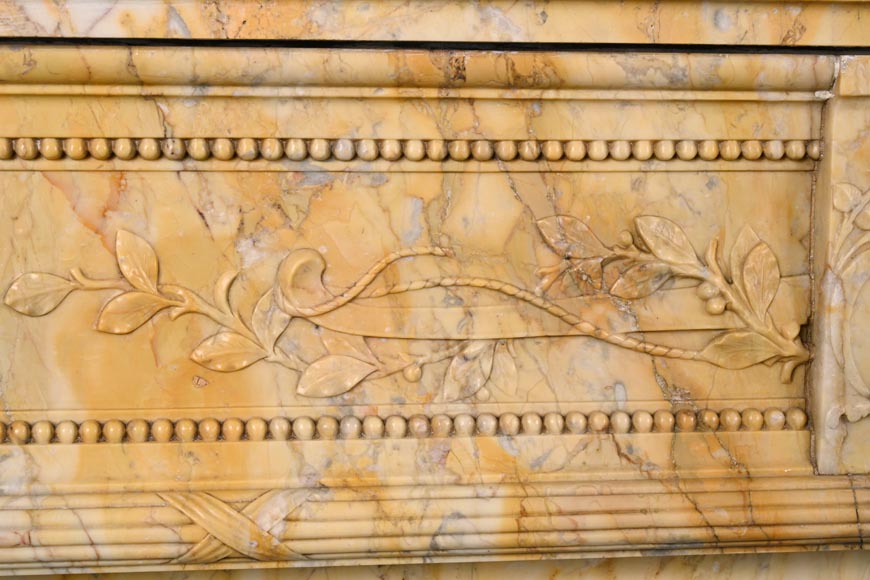 Large Louis XVI style mantel in yellow Sienna marble with entablature adorned with the head of Apollo and arrow heads on the jambs-2