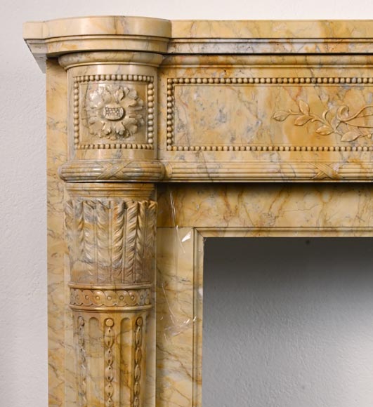 Large Louis XVI style mantel in yellow Sienna marble with entablature adorned with the head of Apollo and arrow heads on the jambs-6