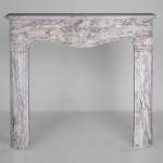 Louis XV style fireplace in Medici Breccia marble with a fleur-de-lys motif in acanthus leaves