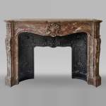 Important Louis XV style fireplace with three shells in Rouge du Nord marble