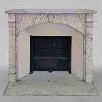 Small and original mantel with a rounded entablature in Arabescato marble