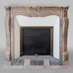 An antique Louis XV style fireplace, Pompadour model, made out of Enjugerais marble