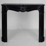 Louis XV style black marble mantel with carved shell
