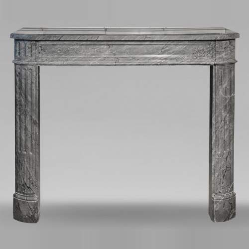 Louis XVI style Bleu Turquin marble fireplace with fluted legs