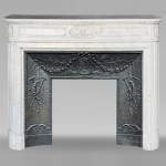 Louis XVI style Carrara marble mantel with rounded corners and carved rose window
