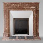 Louis XIV style mantel with acroterion in Rouge du Nord marble