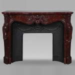 Louis XV style mantel with rich décor of shells and volutes in Griotte marble