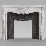 Louis XV style mantel richly decorated with shells and acanthus leaves carved in Carrara marble