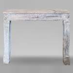 Louis XVI period stone mantel adorned with hunting figures and musical instruments