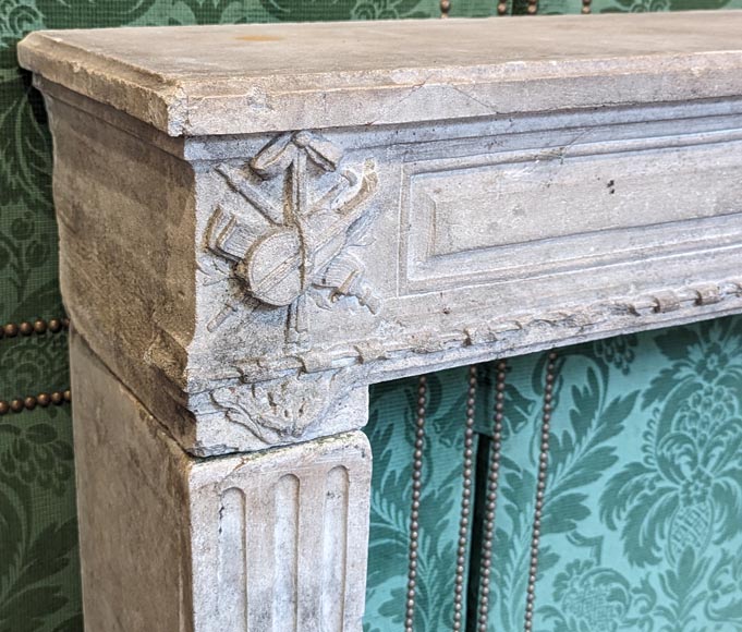 Louis XVI period stone mantel adorned with hunting figures and musical instruments-3