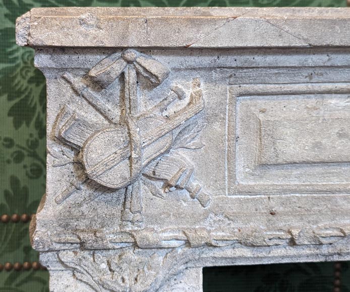 Louis XVI period stone mantel adorned with hunting figures and musical instruments-4