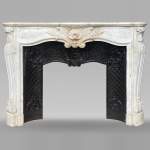 Louis XV style mantel with shell framed by palmettes carved in Carrara marble
