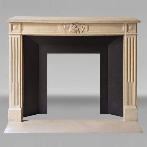 Louis XVI style stone mantelpiece with military trophy
