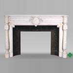 Louis XVI style white marble fireplace with rounded columns and female profile medallion