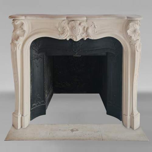 Louis XV style stone mantel with asymmetrical shell design