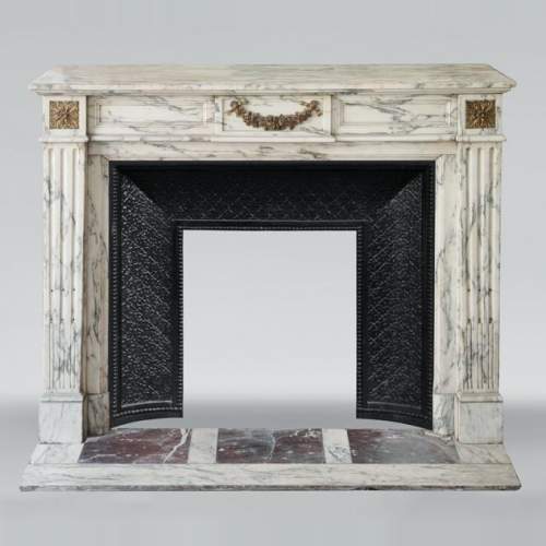 Louis XVI style fireplace in Arabescato marble decorated with a garland of gilded bronze flowers