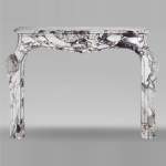 Louis XV style fireplace in purple breccia, decorated with a shell