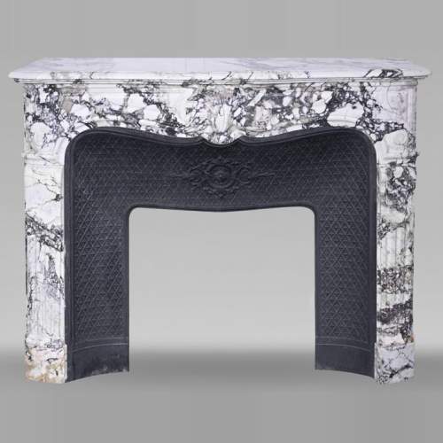 Regency style fireplace in purple breccia, decorated with a large shell