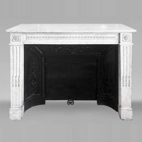 Louis XVI style fireplace in Carrara marble, decorated with ribbons and floral rosettes