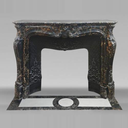 Louis XV style fireplace in richly sculpted Portoro marble