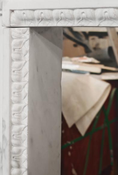 A Louis XVI period fireplace in veined Carrara marble, decorated with a Greek-style frieze.-5