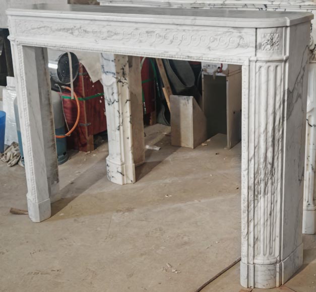 A Louis XVI period fireplace in veined Carrara marble, decorated with a Greek-style frieze.-6