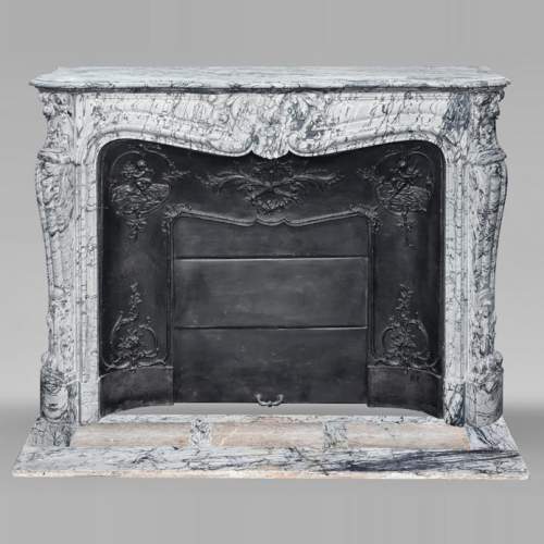 Louis XV style fireplace decorated with a shell motif, in blue floral marble