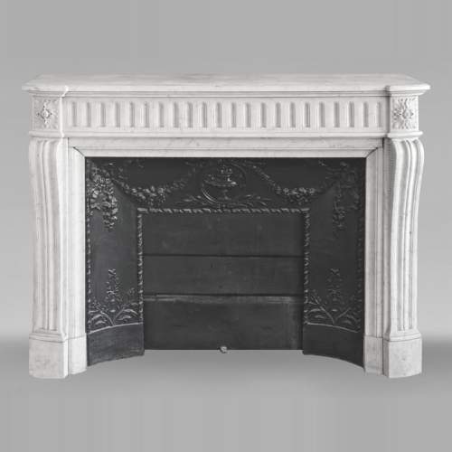 Louis XVI style curved mantelpiece in Carrara marble, featuring fluted decoration
