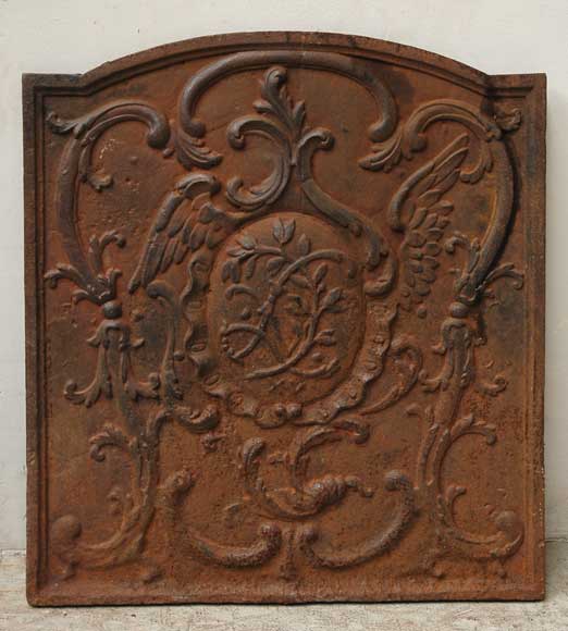 Cast iron fireback with winged monogram Firebacks