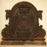 Antique cast iron fireback with the Le Juge family coat of arms and two dogs