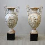 Antique pair of cast iron vases with putti